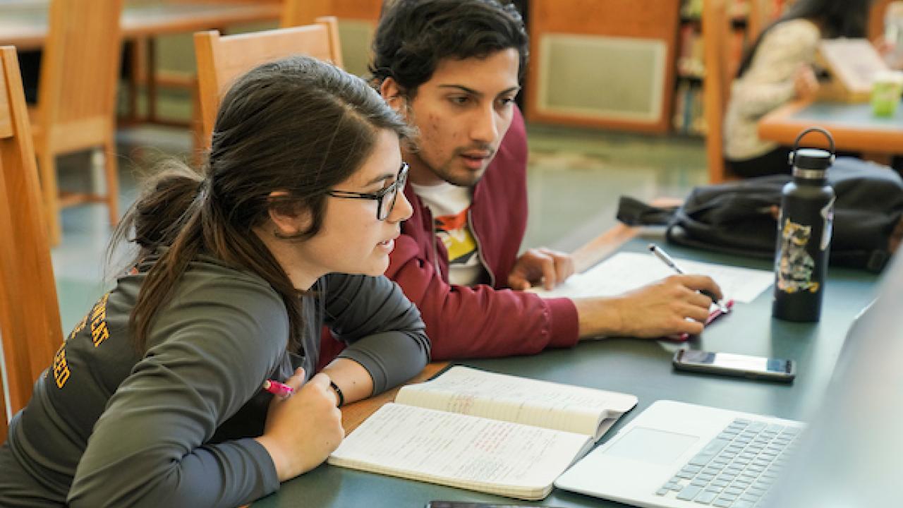 students studying with open textbooks