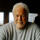 John Vons headshot sitting at a desk 